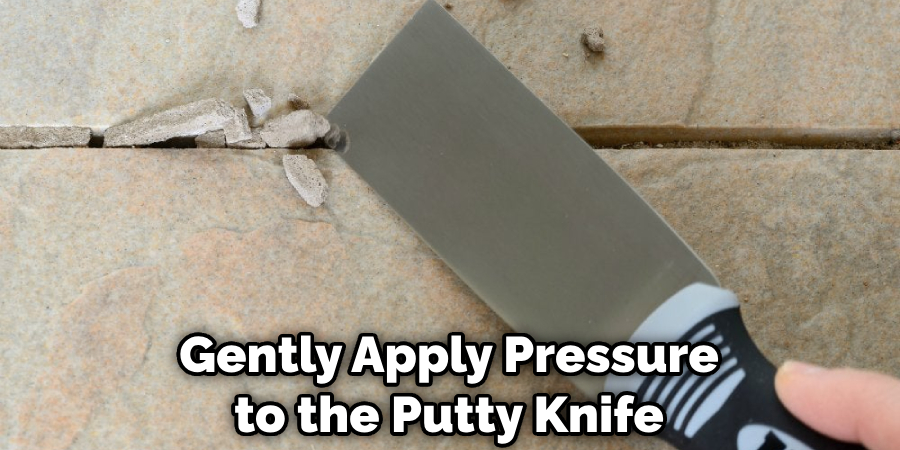 Gently Apply Pressure to the Putty Knife